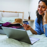 Woman using laptop to book travel reservation