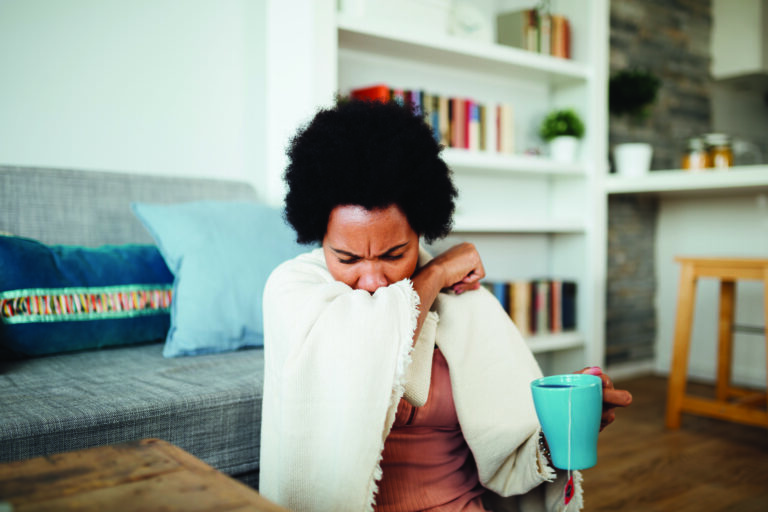 Sick African American woman staying at home